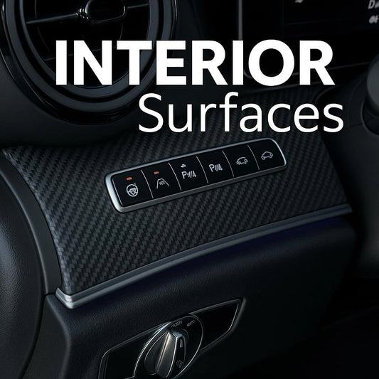 Close-up of 3D carbon fiber matte vinyl wrap applied on car interior dashboard with control buttons.