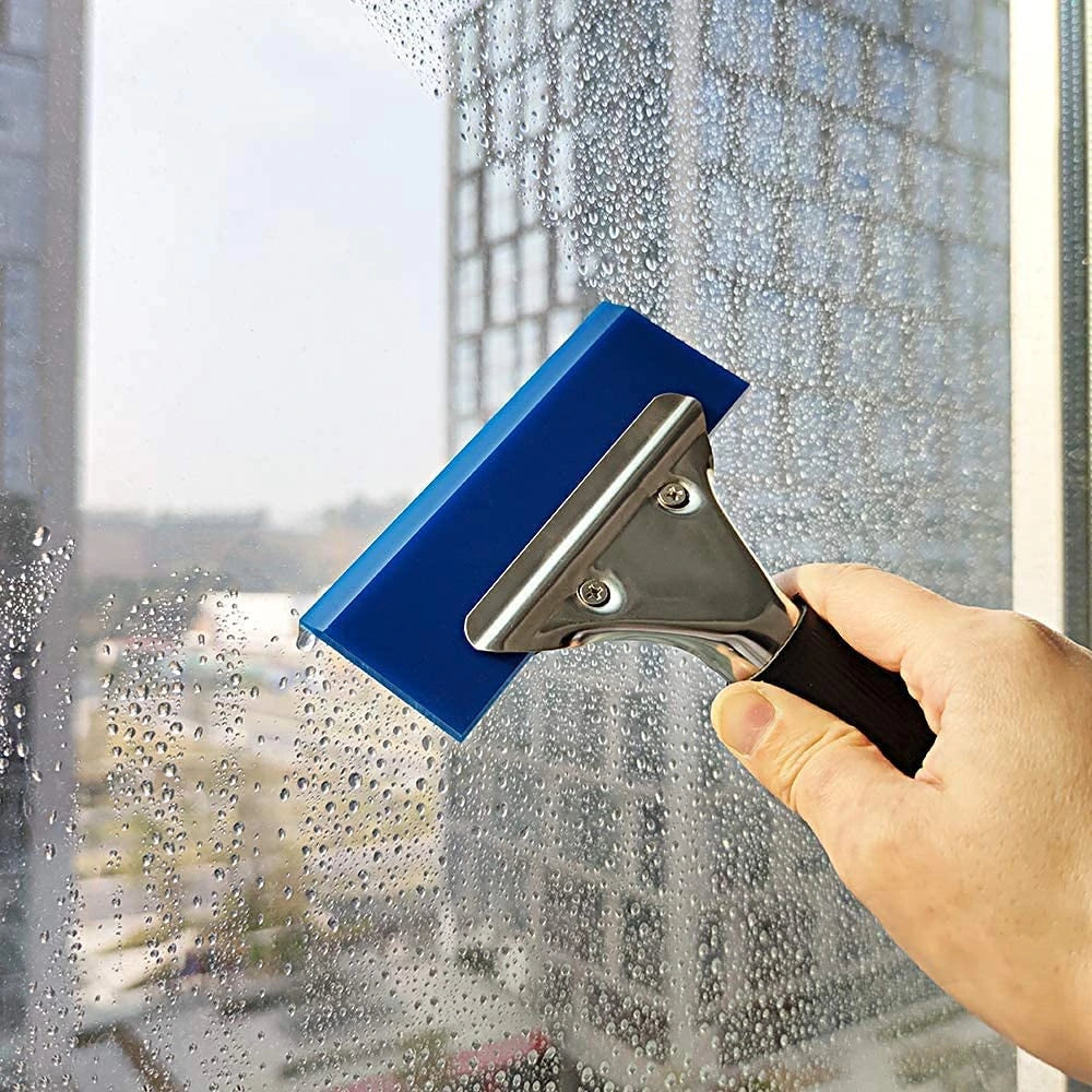 Using a blue Pro 5-in Rubber Blade Squeegee on a window