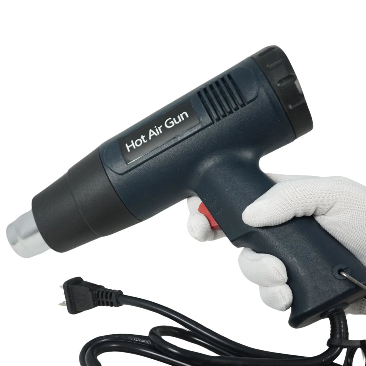 Black hot air gun held by a gloved hand on a white background