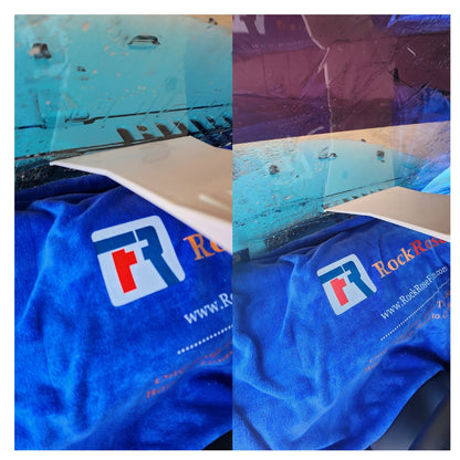 Blue towel with a logo and text, shown on a textured surface.