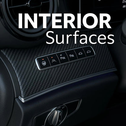 Close-up of 3D carbon fiber matte vinyl wrap applied on car interior dashboard with control buttons.