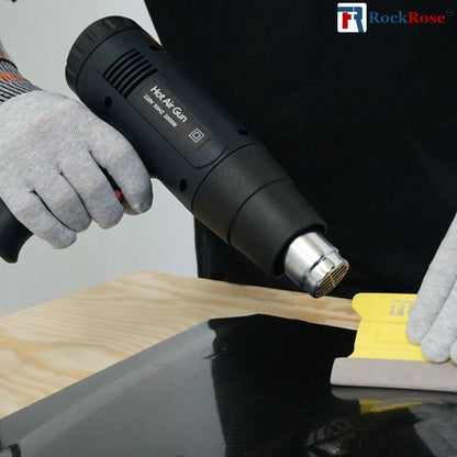 Hot air gun being used on a wooden surface with RockRose branding.