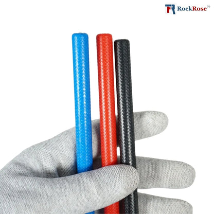 Holding a 3 pieces mini squeegee colored blue red and black on a left hand with gloves