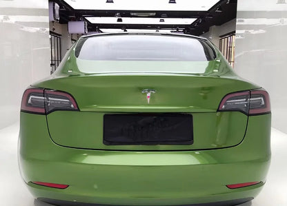 Green Tesla car in a showroom setting