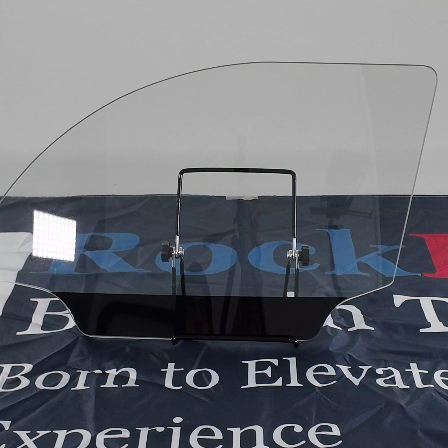 Clear windshield with black frame on a branded background