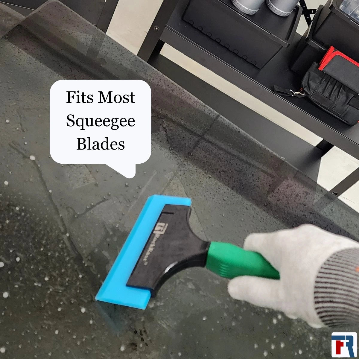 Holding a green squeegee using a glove with blue tint scrapper and rockrose logo 