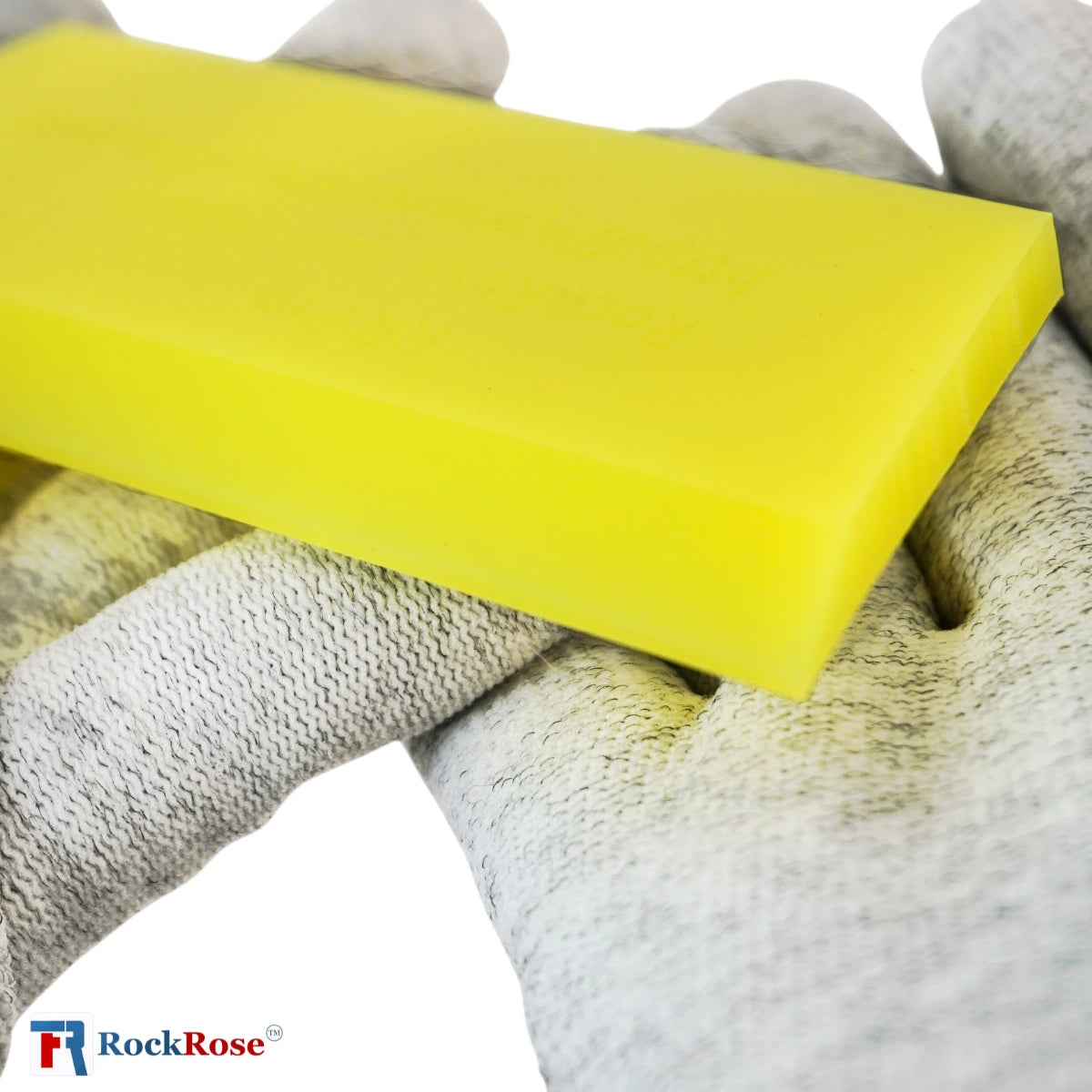 Yellow squeegee  held by a gloved hand with RockRose logo.