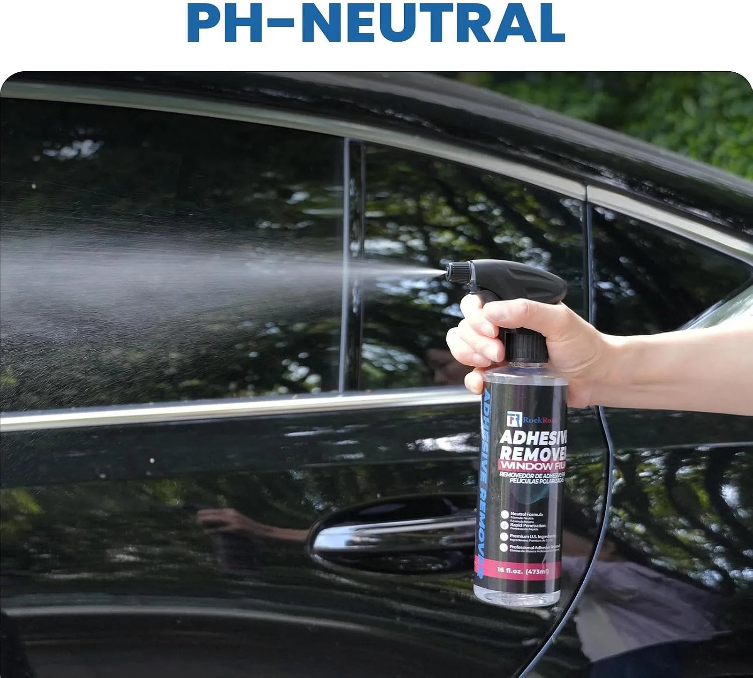 Person using a spray bottle labeled 'Adhesive Remover' on a car window with 'PH-NEUTRAL' text above.