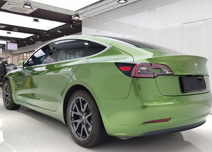 Green Tesla car on display in a showroom by rockrose film wrap