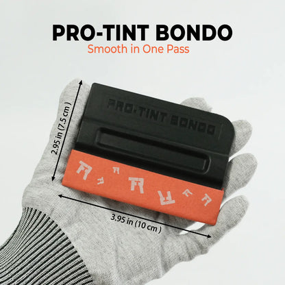 A gloved hand holds a RockRose Black Wing Squeegee – 3.9 Pro-Tint Bondo smoothing tool with dimension arrows and text reading 'PRO-TINT BONDO' and 'Smooth in One Pass' on a light gray background.