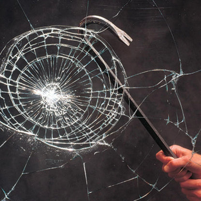 Hand holding a crowbar against a shattered glass window