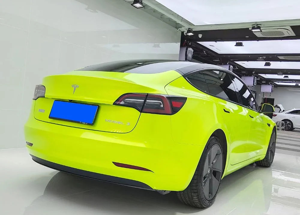 Lime green Tesla car in a showroom setting 
