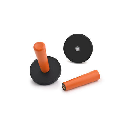 Three Vinyl Wrap Magnet Tool including a black base with an orange cylindrical object, a black disc with a central hole, and another orange cylindrical object on a white background.