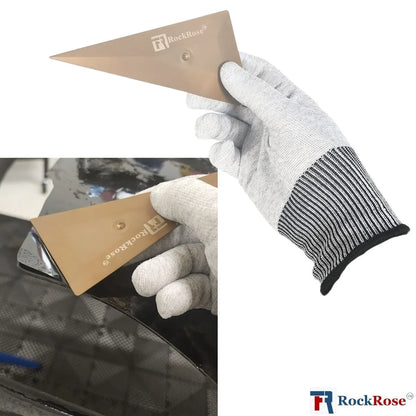 Hand holding a sanding block with 'RockRose' branding, wearing a gray glove.