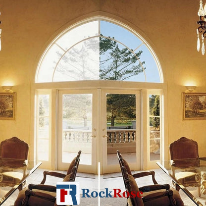 Living room with large arched window, chairs, and a chandelier.