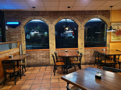 Dining area with tables, chairs, and a brick wall. with nano ceramic tint