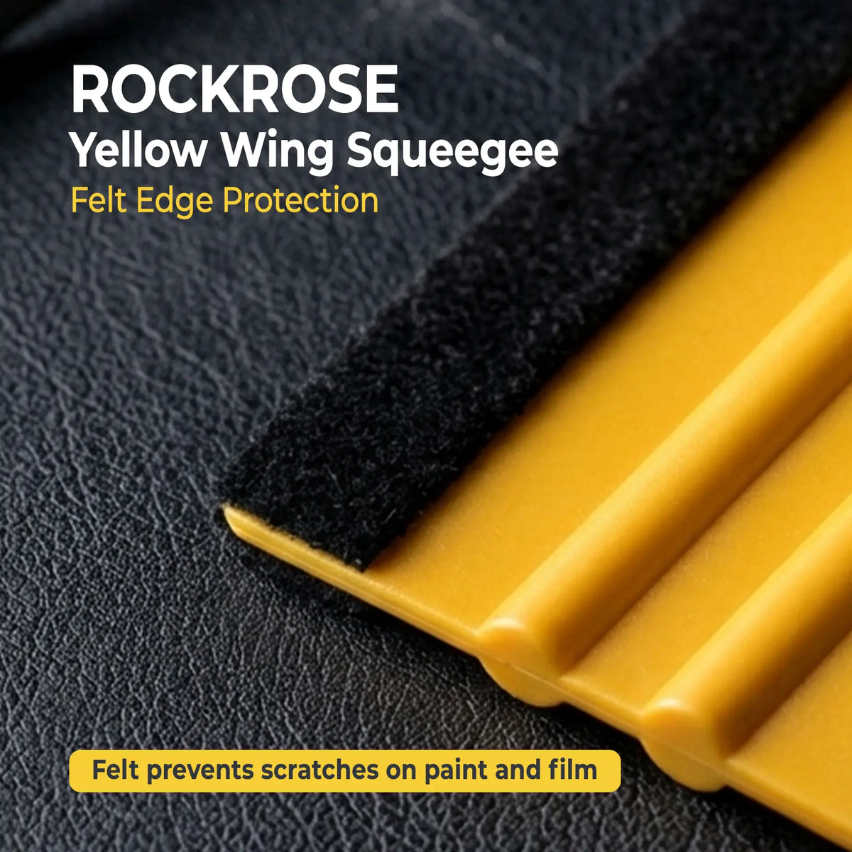 Close-up of yellow plastic wing squeegee edges with a black felt protective strip, shown on a dark textured surface with text reading 'ROCKROSE Yellow Wing Squeegee' and 'Felt Edge Protection'.