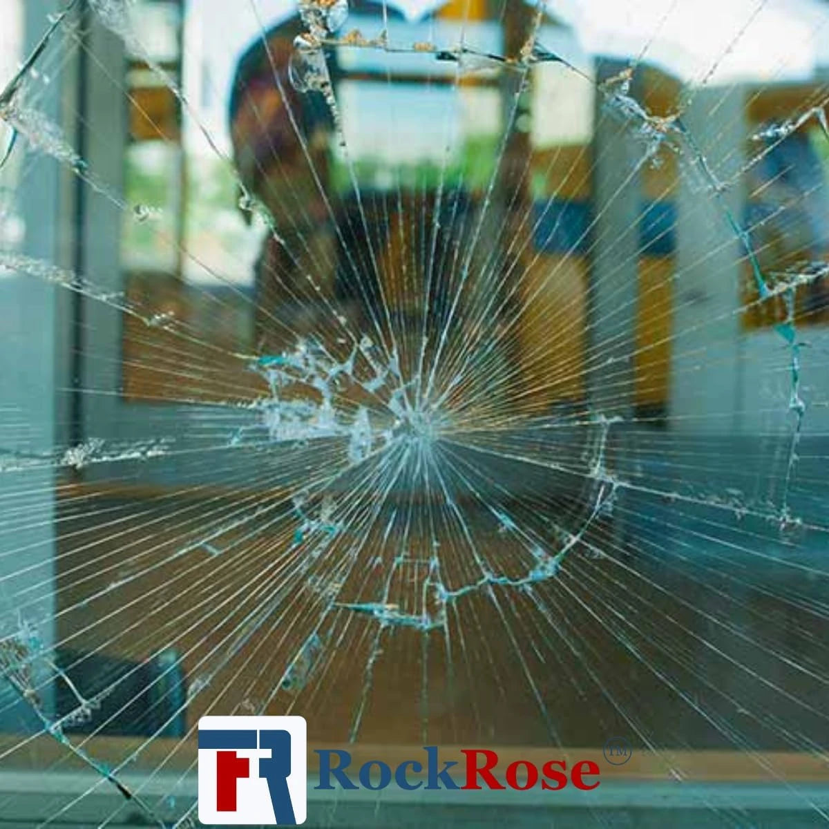 Shattered glass with a blurred background and 'RockRose' logo.