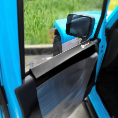 Close-up of a blue vehicle door with a side mirror and side mirror on green grass background
