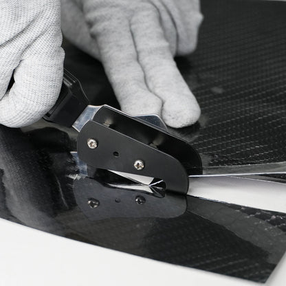 Person using a car window cutter tool removal tool on a car window.