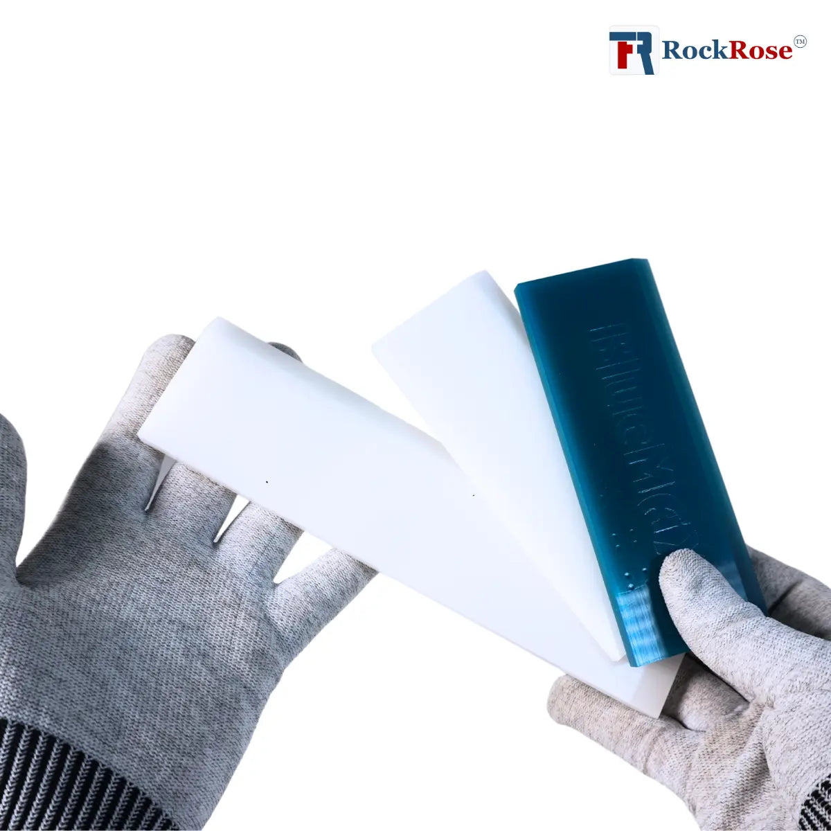 Person wearing gray gloves holding a white and blue product with RockRose branding.