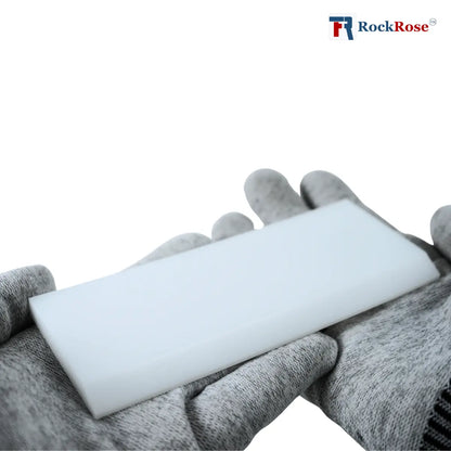 Hand wearing a gray glove holding a white plastic with 'RockRose' branding.