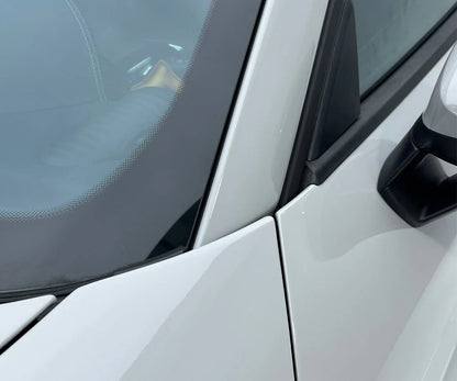 Close-up of a car door with a side mirror on a white vehicle