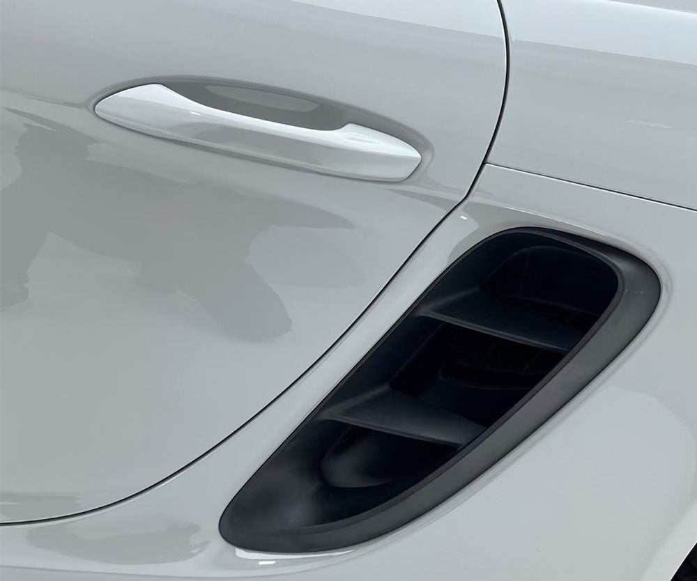 White colored car with door handle and black fender fin