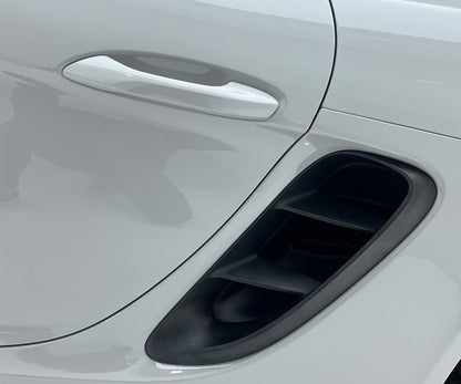 White colored car with door handle and black fender fin